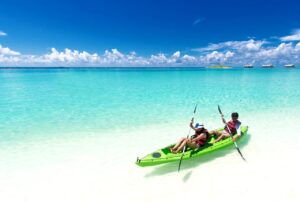 Two People Riding Green Kayak On Sea